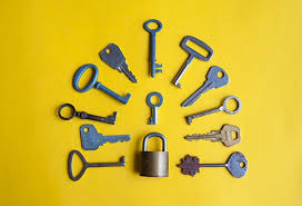 Stock image of various keys spread out around a padlock. 