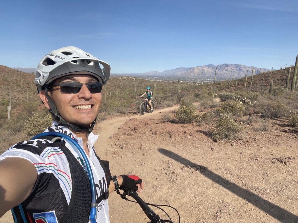 Michael Smitasin biking in a desert location. (Credit: Michael Smitasin/Berkeley Lab)